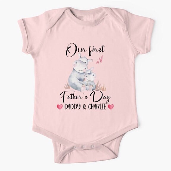 Personalised light pink short sleeved baby onesie bodysuit for daddys first fathers day with the names of both father and child combined with a watercolour painting of a daddy hippopotamus hugging a baby hippo