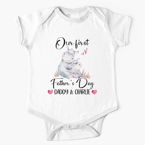 Personalised white short sleeved baby onesie bodysuit for daddys first fathers day with the names of both father and child combined with a watercolour painting of a daddy hippopotamus hugging a baby hippo