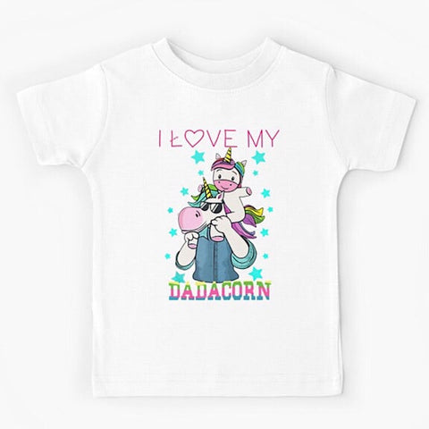 White short sleeved kids tshirt with a muscly white father unicorn wearing a denim button down shirt with a baby unicorn on his shoulders with the words I love my dadacorn underneath