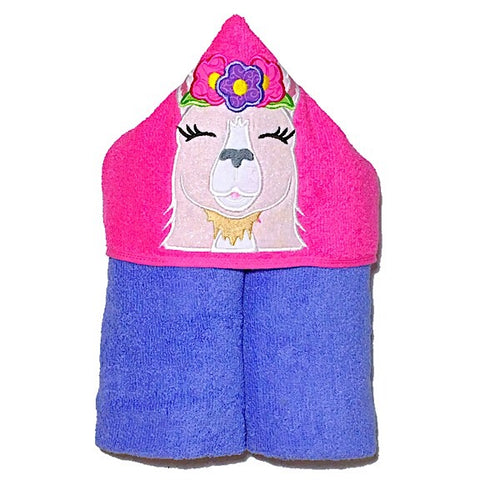 Hooded bath beach swim towel in purple with pink hood. Hood has the face of a smiling white glittery llama wearing a flower crown appliquéd in the centre. Ready to be personalised with a name.