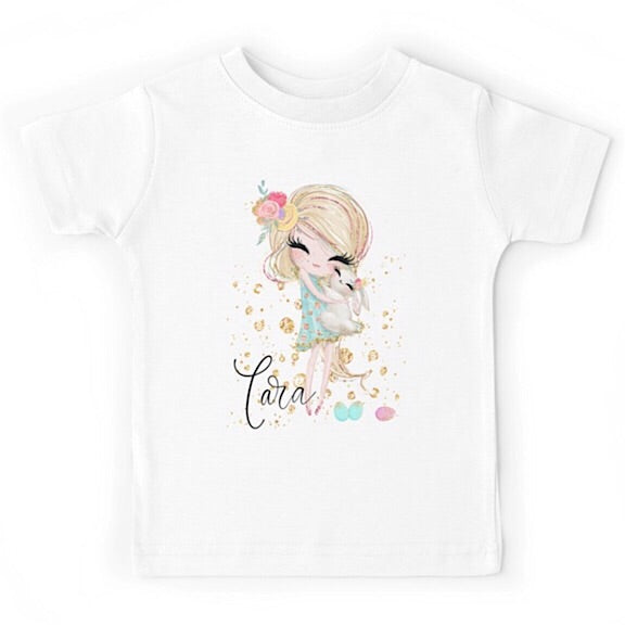 White short sleeved tshirt with a blonde haired girl cuddling a white bunny, personalised with a name