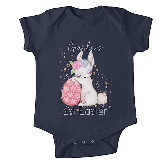 Short sleeved dark blue baby onesie for a first easter with a sleepy bunny resting against an Easter egg  personalised with a name