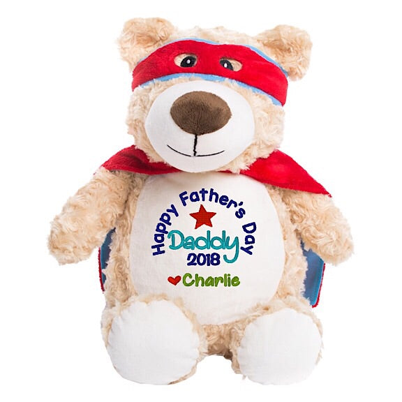 Light brown shaggy teddy bear plushie with red super hero cape and mask with white belly embroidered with Happy Father's Day Daddy and personalised with the names of his children