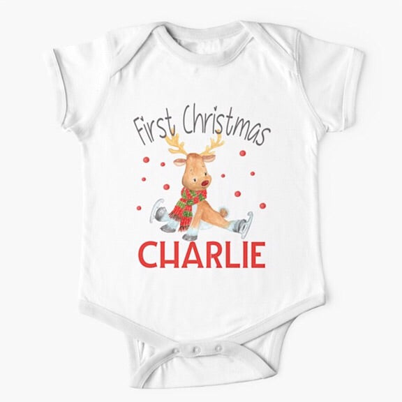 Personalised white short sleeved baby onesie bodysuit for first Christmas with a reindeer wearing a red and green scarf trying to ice skate