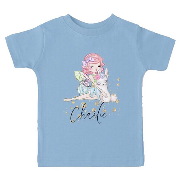 Light blue short sleeved tshirt with a fairy girl cuddling a white easter bunny, personalised with a name