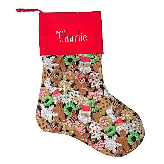 Large Christmas Stocking with glitter Santas, wreaths, Christmas trees, snowflakes, bows, cookies, skates and gingerbread men, with a red cuff personalised with a name
