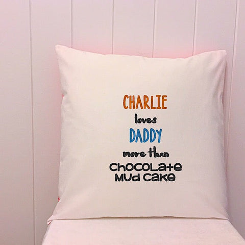 White cushion embroidered with Charlie Loves Daddy more than Chocolate Mud Cake perfect for a personalised fathers day present