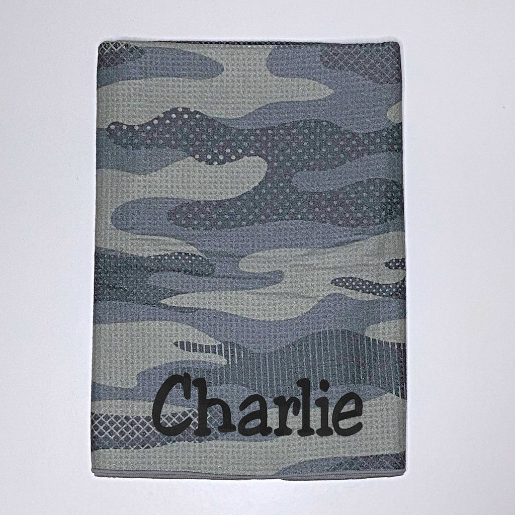 Beach towel in green camouflage colours personalised with a name.