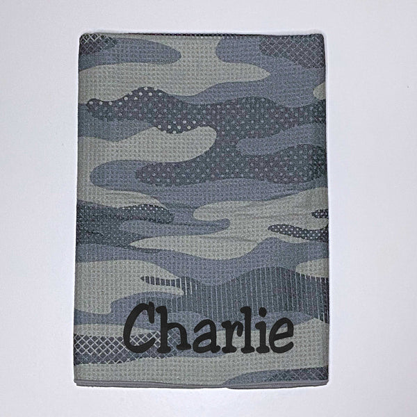 Beach towel in green camouflage colours personalised with a name.