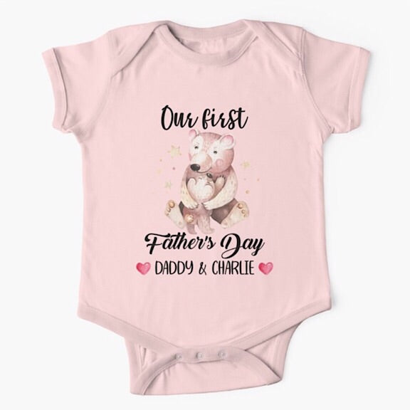 Personalised light pink short sleeved baby onesie bodysuit for daddys first fathers day with the names of both father and child combined with a watercolour painting of a papa bear hugging a baby bear