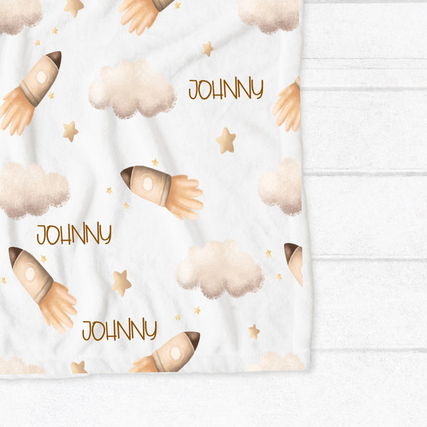 Personalised fleece minky blanket with a rocket taking off among the clouds and stars